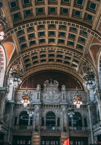 a building with statues and a large arched ceiling